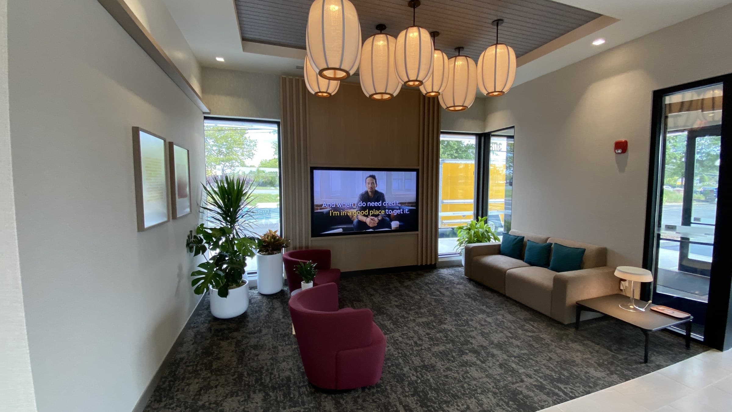 Finished bank branch lounge with lantern pendant lighting and custom millwork by Deerfield Interiors, New York City