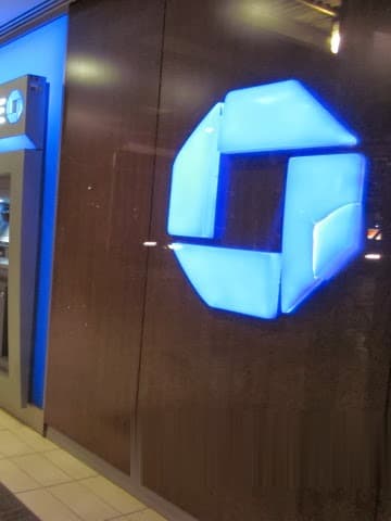 Chase bank interior millwork by Deerfield Interiors — illuminated logo wall and branded ATM line, New York City