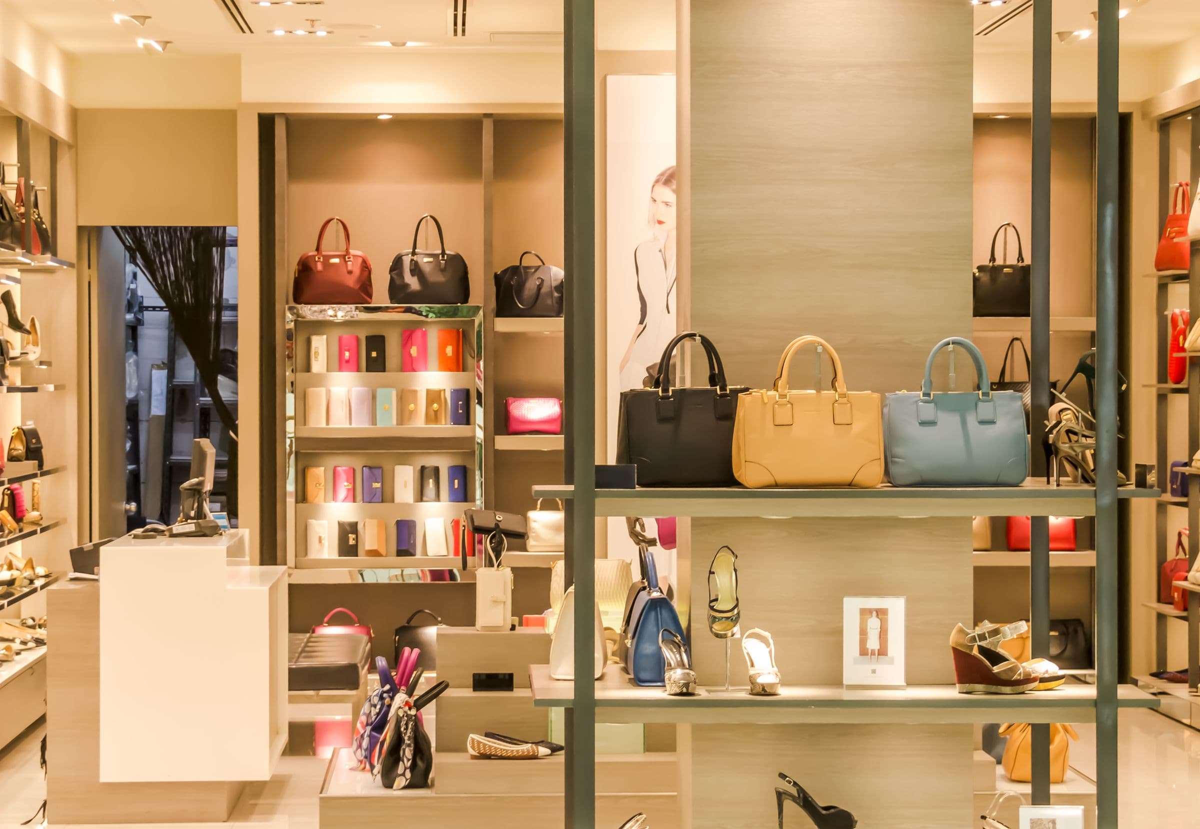High-end retail boutique with built-in illuminated display millwork and brand-integrated fixtures — retail buildout by Deerfield Interiors, New York City